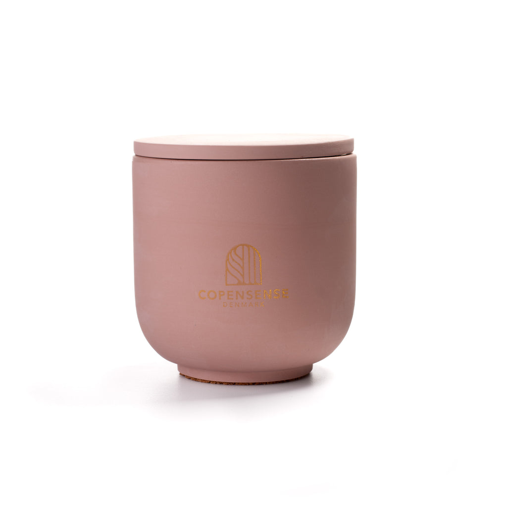 Pure Whisper Scented Candle in Dusty Rose jar. Cotton flower and musk notes. Minimalist Danish design.