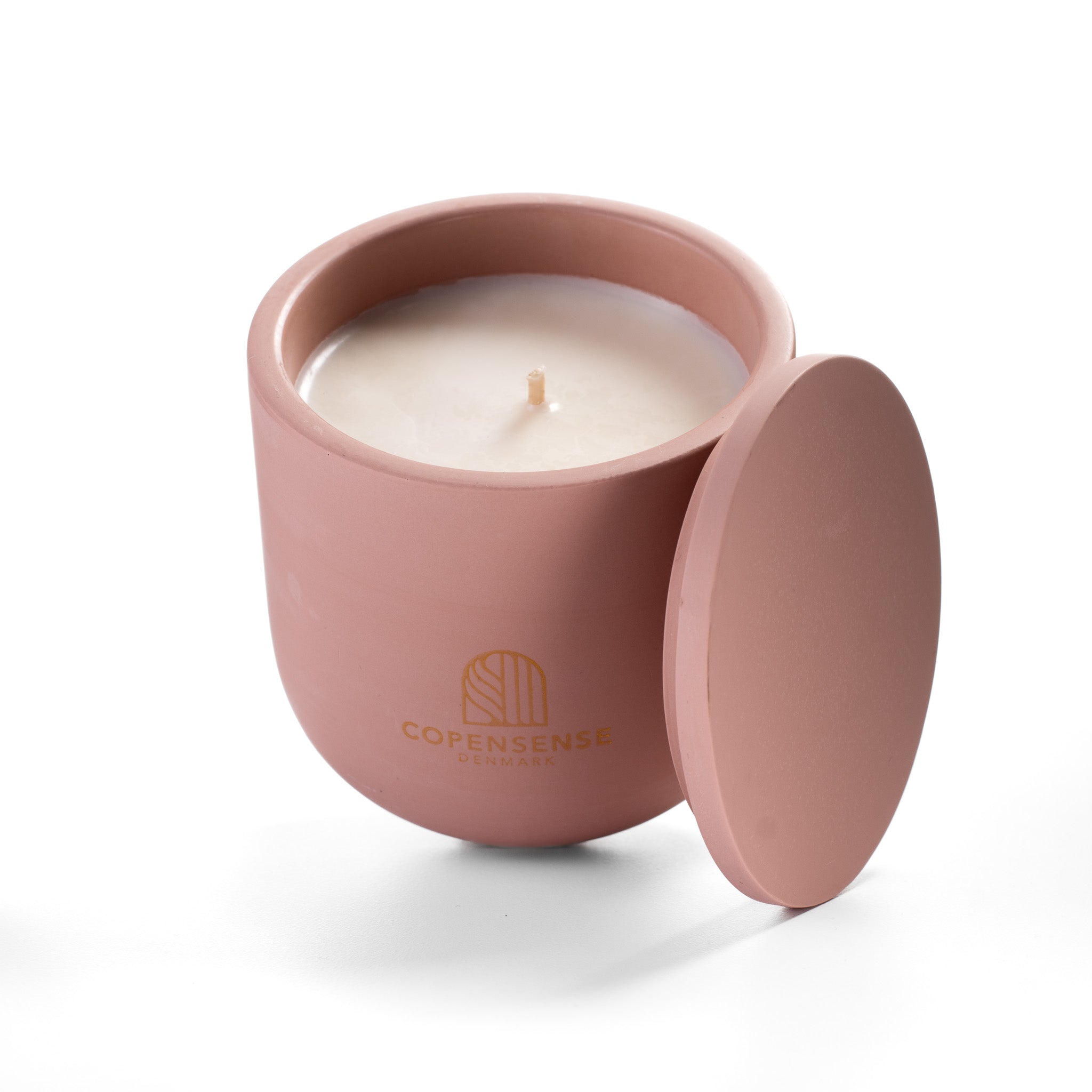 Open Pure Whisper candle showing creamy rapeseed wax and cotton wick inside pink ceramic vessel.