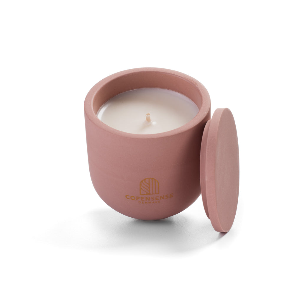 Open Pure Whisper candle showing creamy rapeseed wax and cotton wick inside pink ceramic vessel.