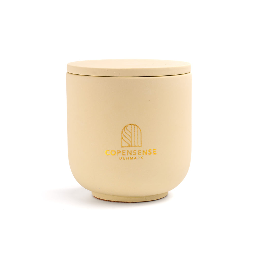 Intense Silence scented candle in a solid Butter Yellow jar, hand-poured in Denmark